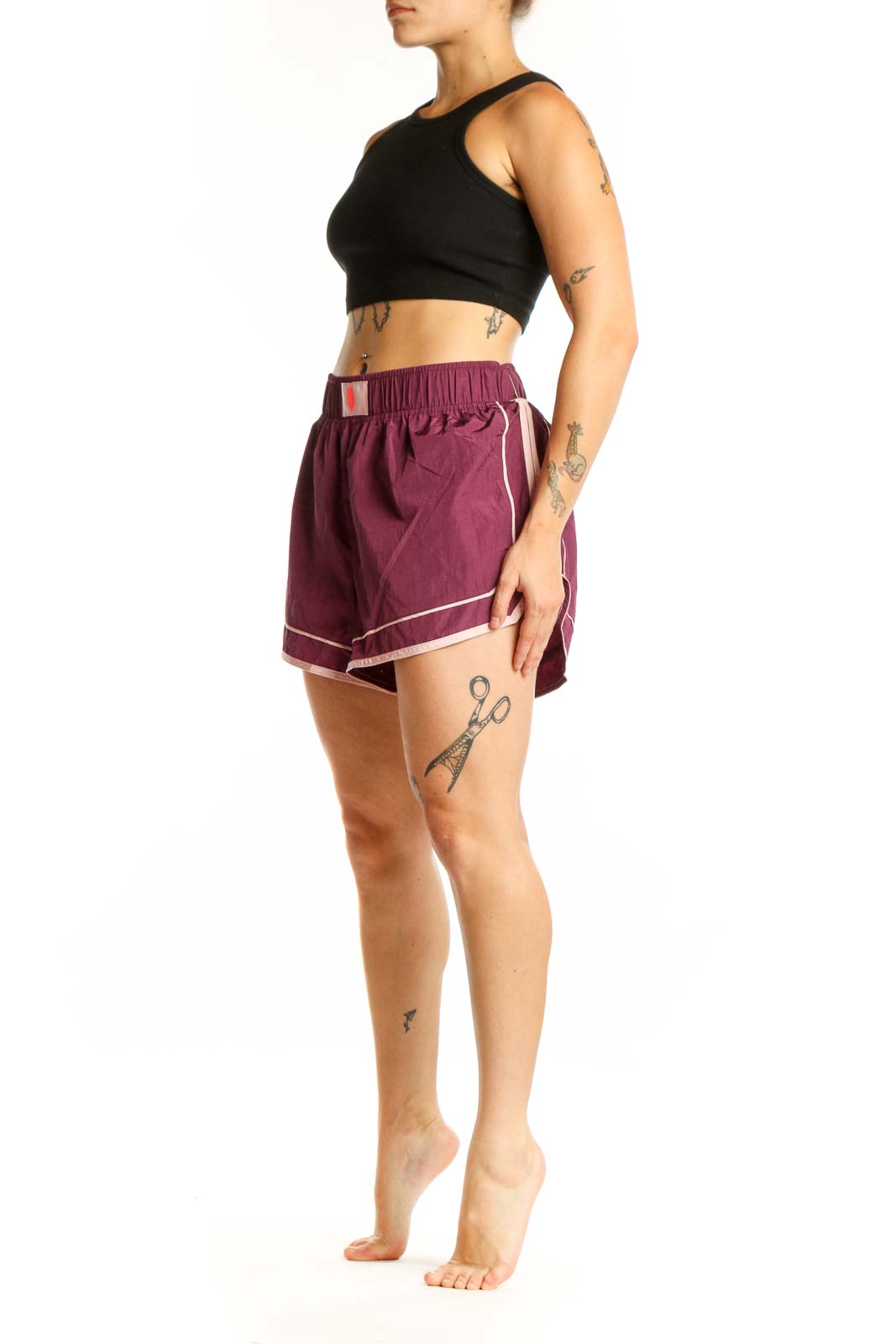 Burgundy athletic shorts with white contrast trim and elastic waistband, front view
