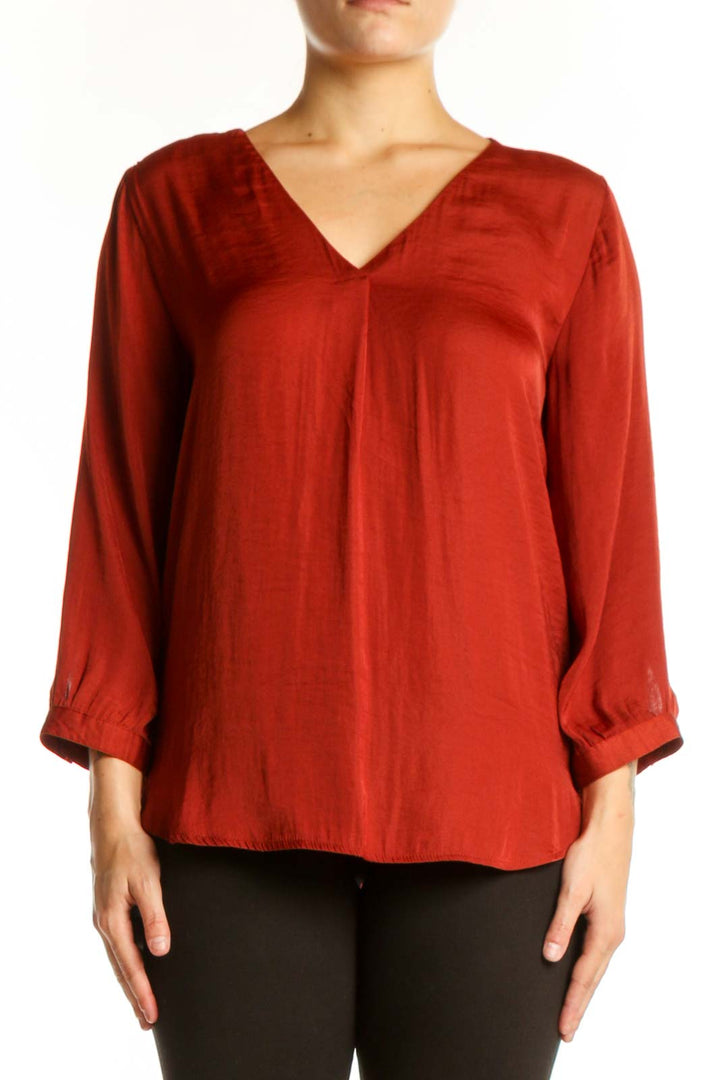 Red V-neck blouse with three-quarter sleeves and rolled cuffs, front view