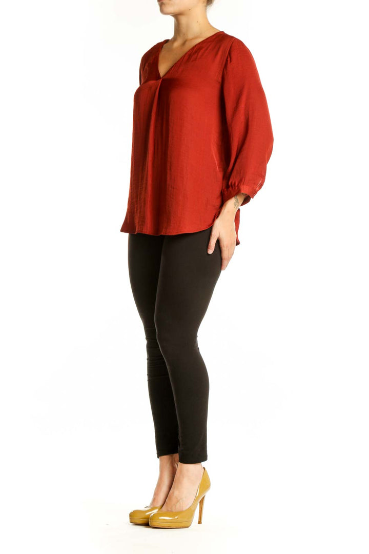 Red V-neck blouse with three-quarter sleeves and rolled cuffs, front view