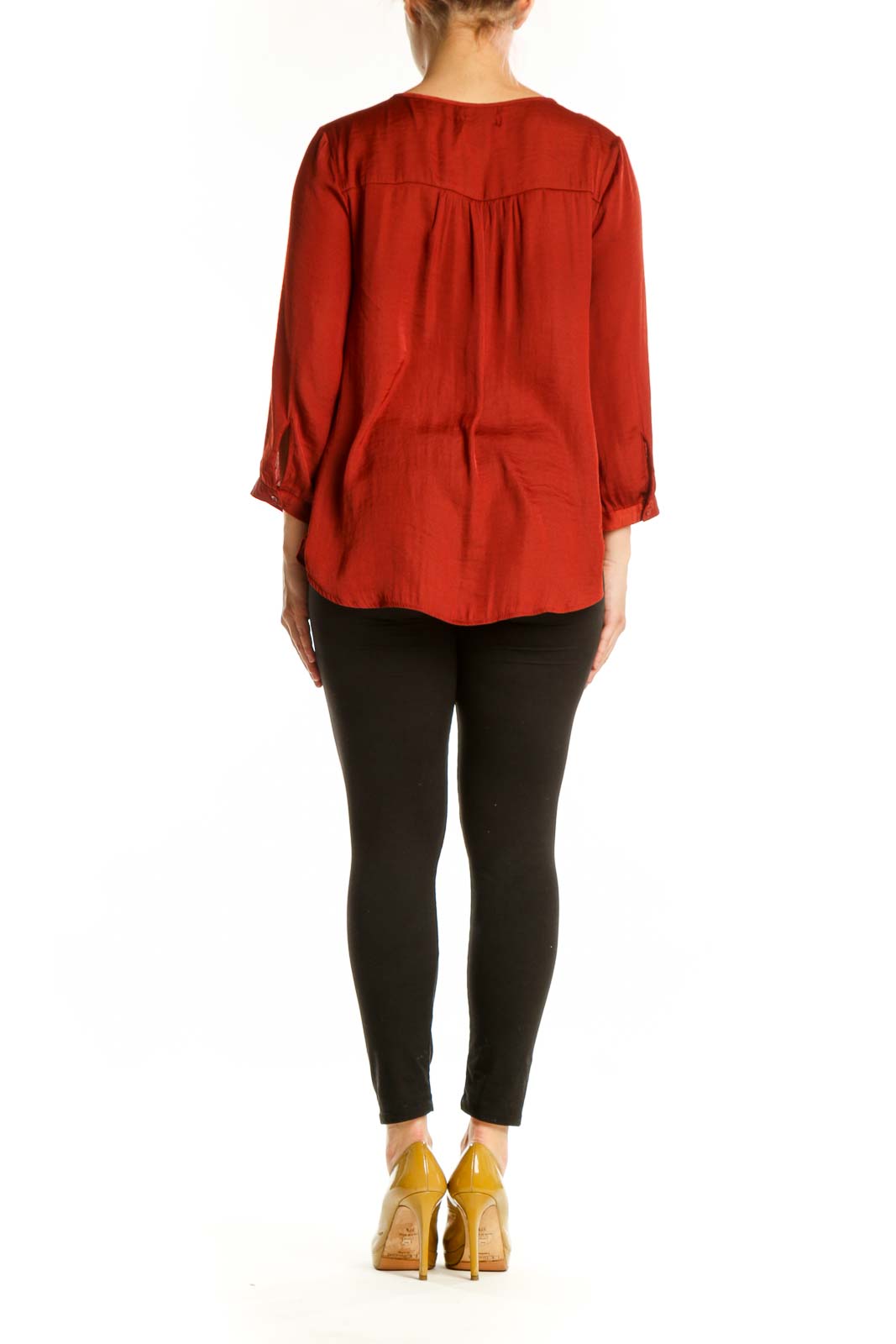 Red V-neck blouse with three-quarter sleeves, back view, styled with black pants