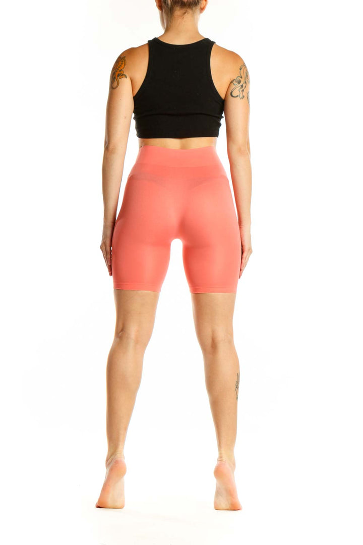 Coral high-waist biker shorts back view, form-fitting athletic shorts