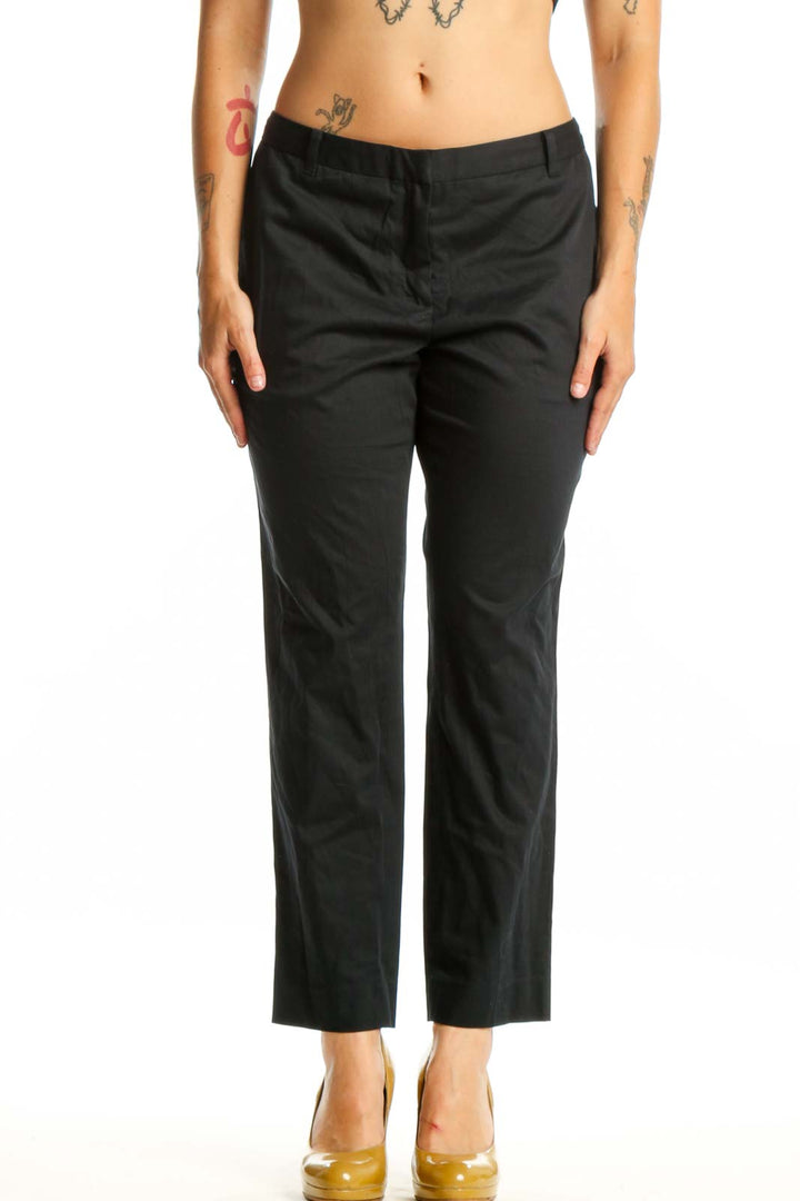 Black cropped dress pants from Allsaints, front view showing straight leg silhouette and cropped ankle length on size L