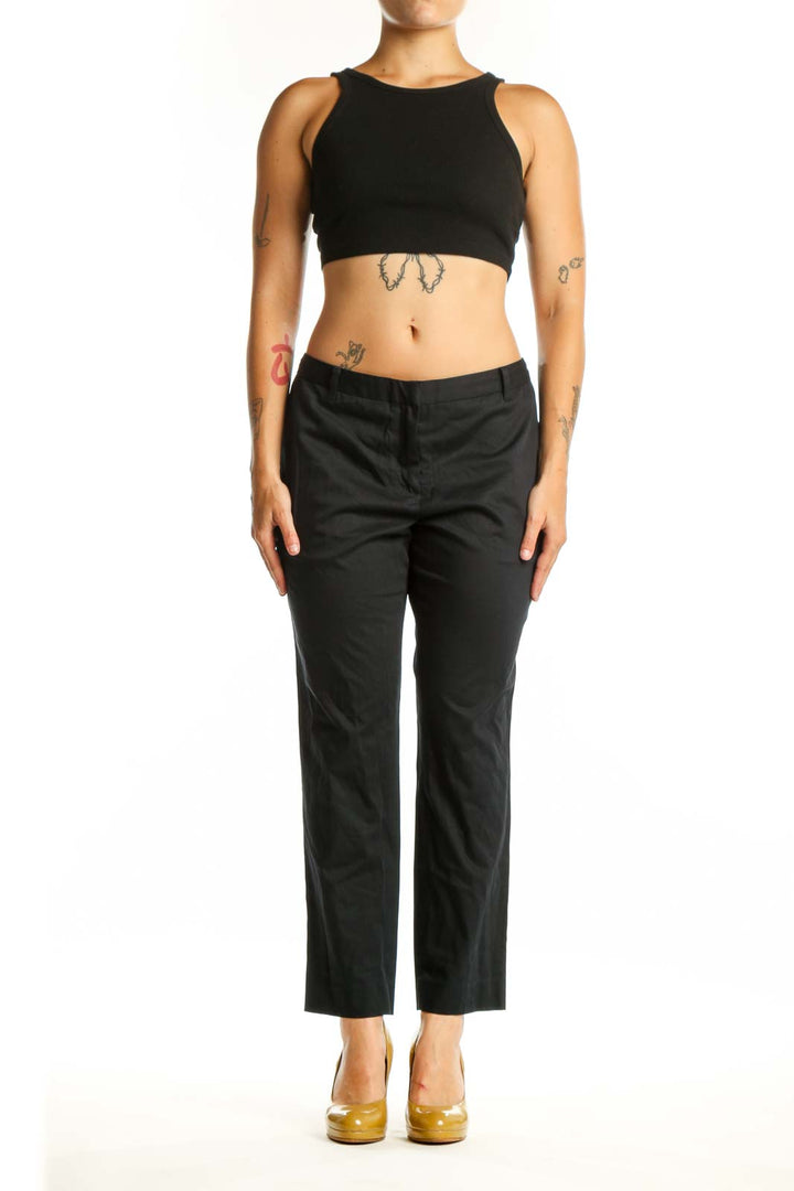 Black cropped dress pants from Allsaints, front view showing straight leg silhouette and cropped ankle length on size L