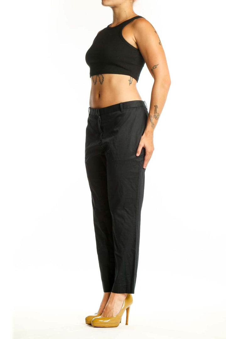 Black cropped dress pants from Allsaints, front view showing straight leg silhouette and cropped ankle length on size L
