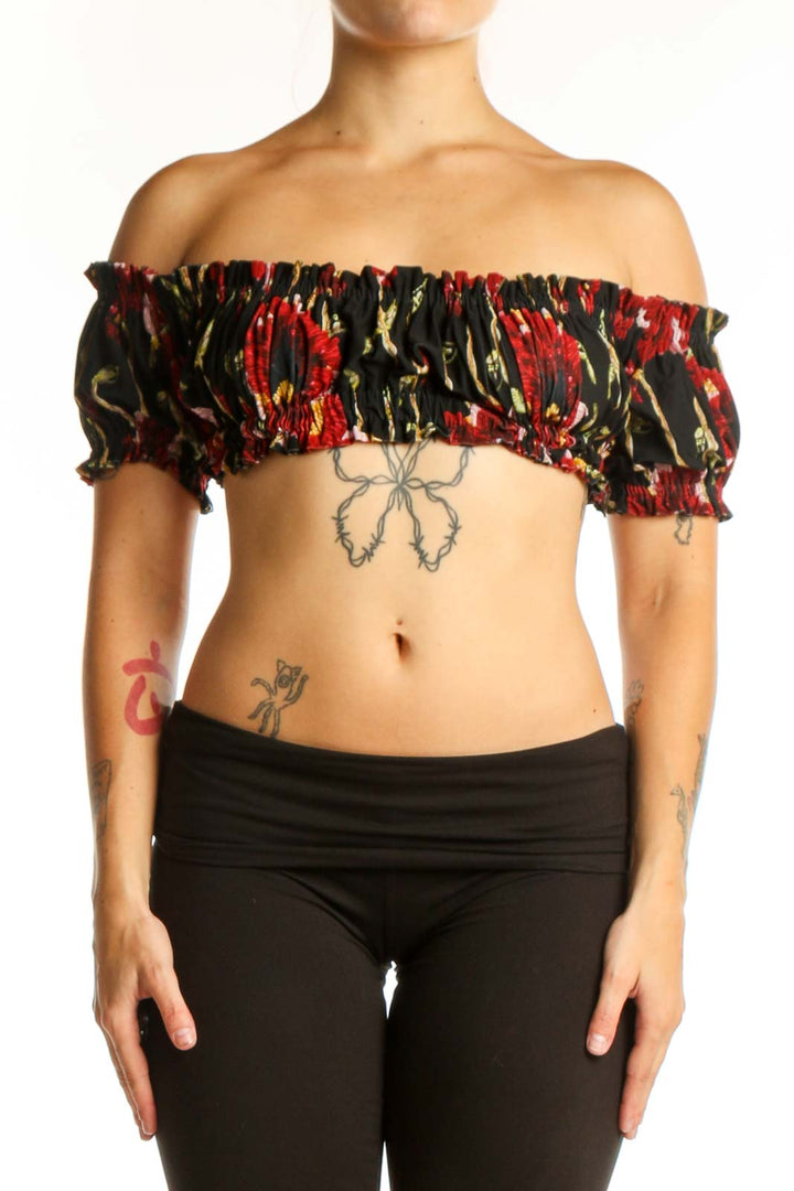 Black floral off-shoulder ruched crop top with red and gold botanical print and puffed sleeves, front view