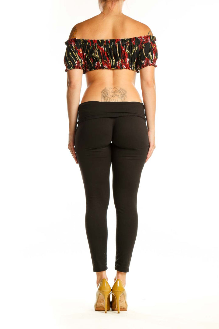 Black floral off-shoulder ruched crop top with red and gold botanical print, back view