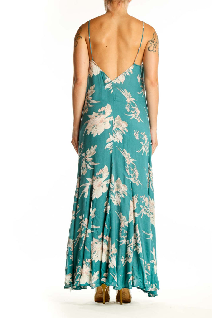 Teal rayon maxi dress with cream floral botanical prints, flowing silhouette, back view