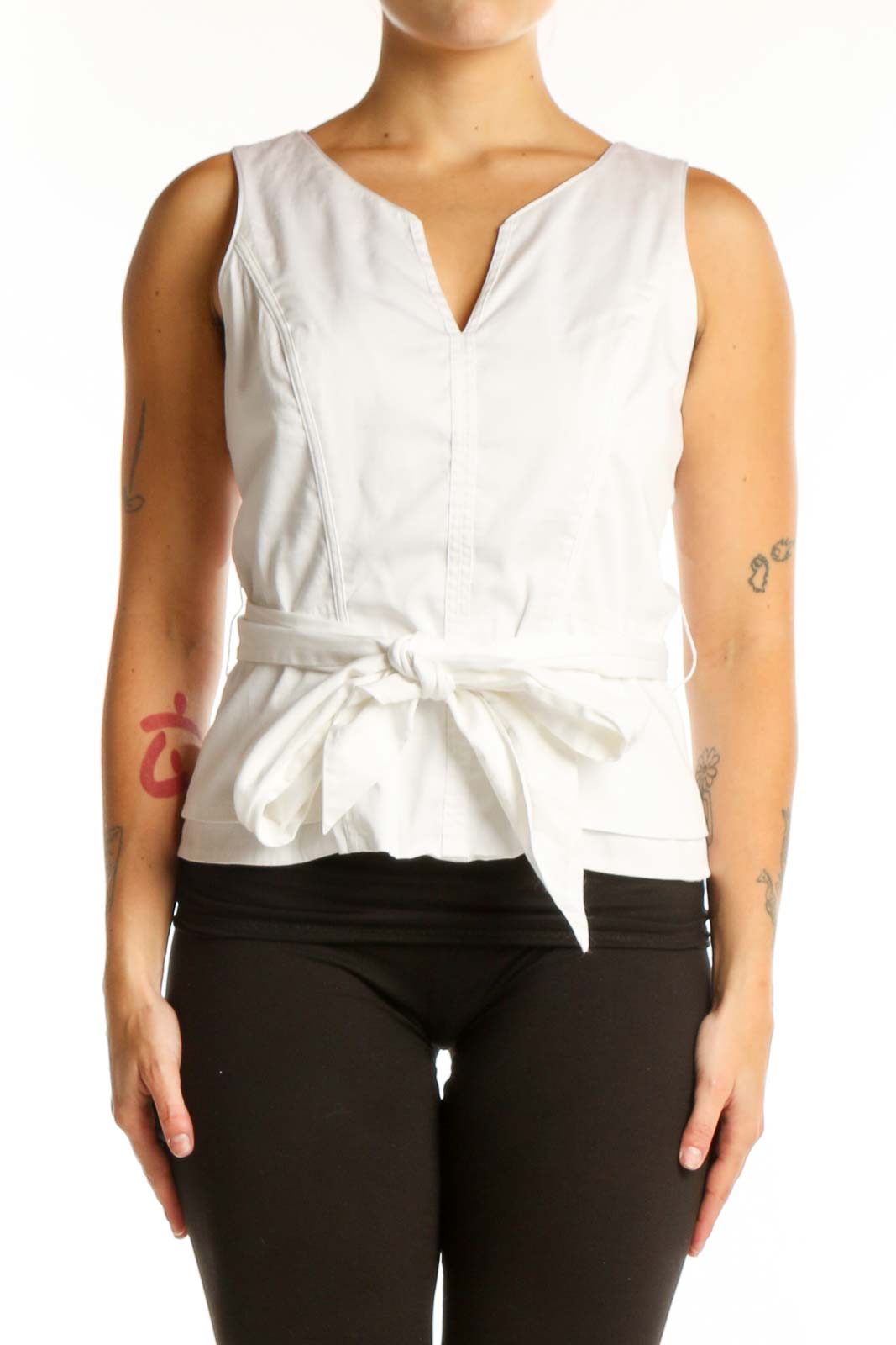 White House Black Market white sleeveless tie-front top with V-neckline and adjustable waist tie, front view on model