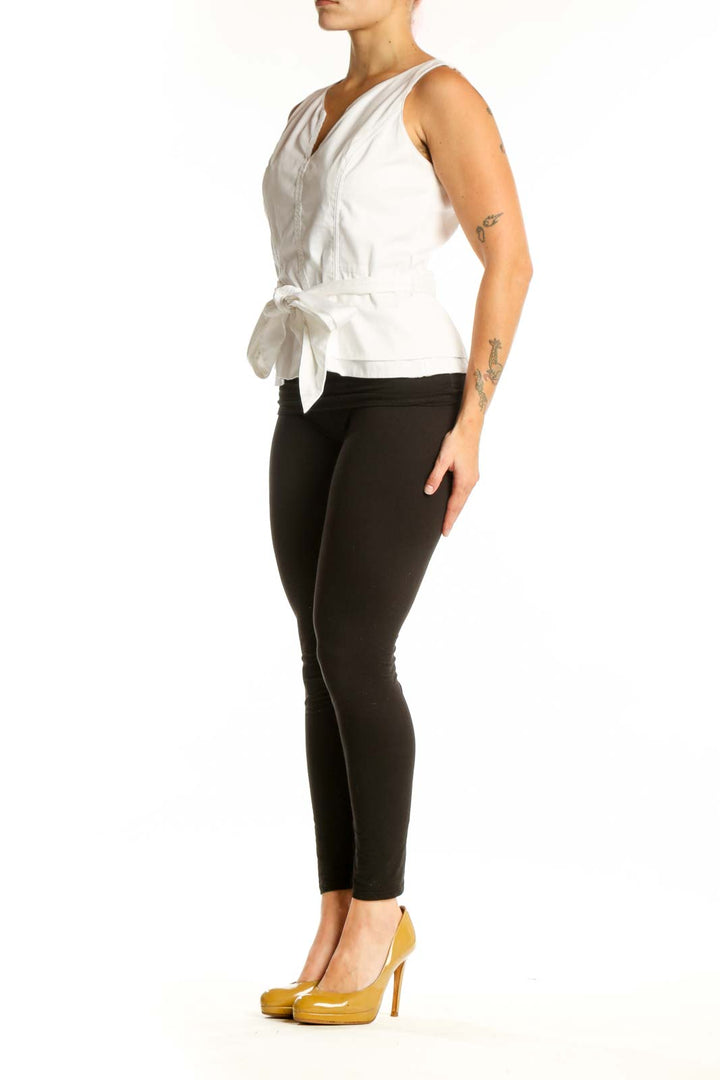 White House Black Market white sleeveless tie-front top with V-neckline and adjustable waist tie, front view on model