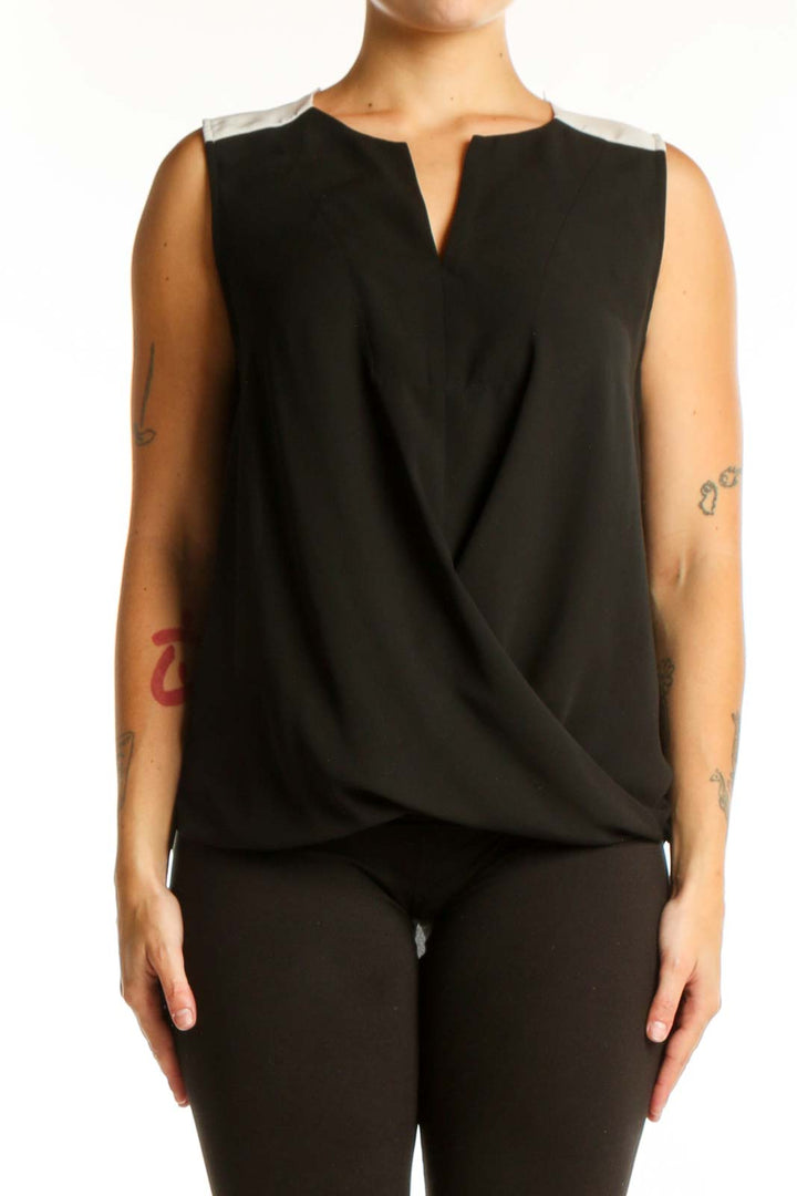 Black wrap sleeveless top with keyhole neckline and wrap-front design, front view