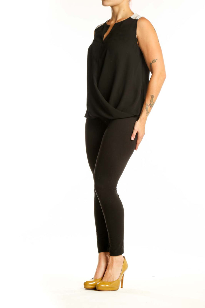 Black wrap sleeveless top with keyhole neckline and wrap-front design, front view