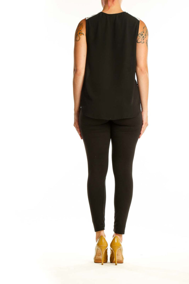 Black wrap sleeveless top back view showing draped wrap detail