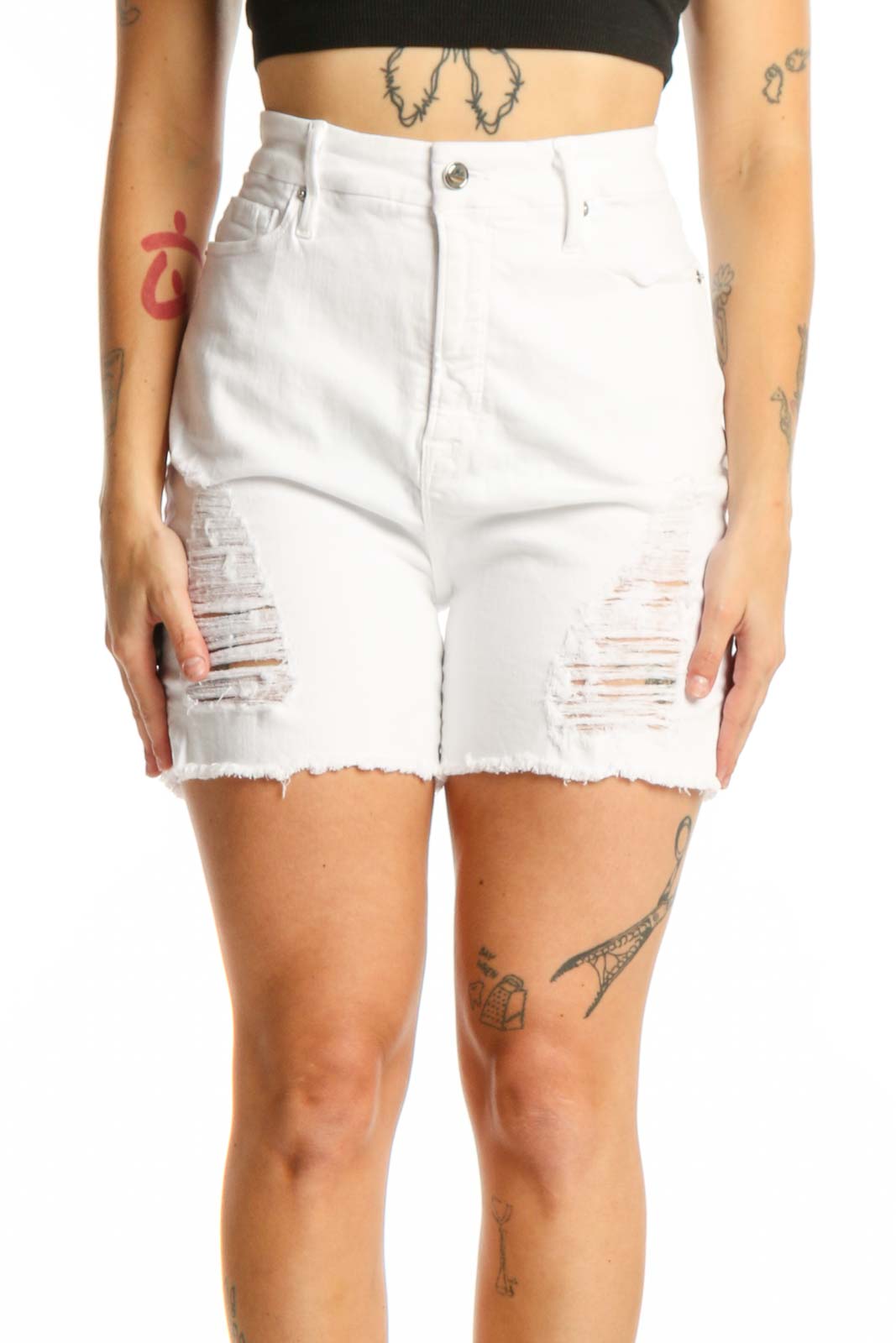 White distressed denim shorts with ripped thigh details and raw cut-off hem, front view