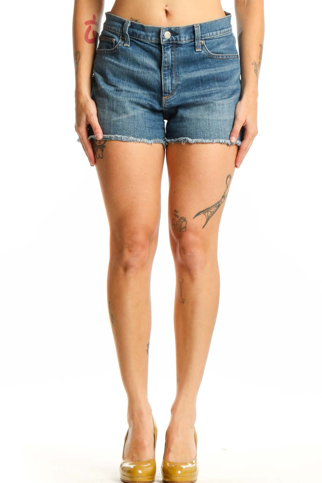 Front view of blue denim cut-off shorts with distressed hem and classic five-pocket design