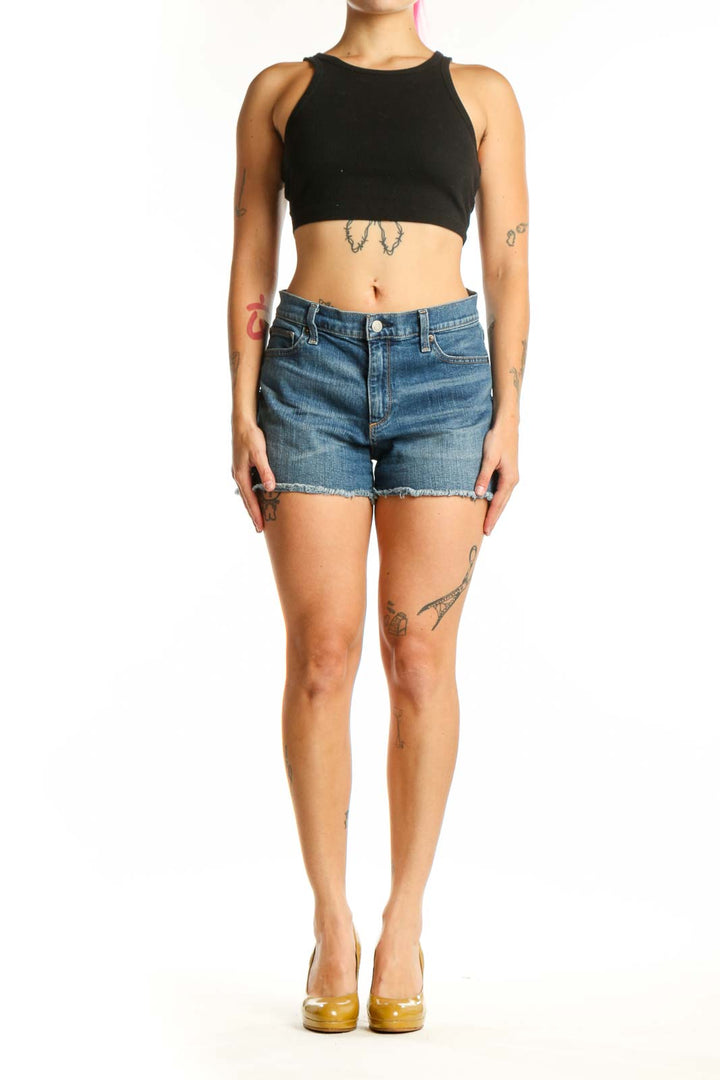 Front view of blue denim cut-off shorts with distressed hem and classic five-pocket design