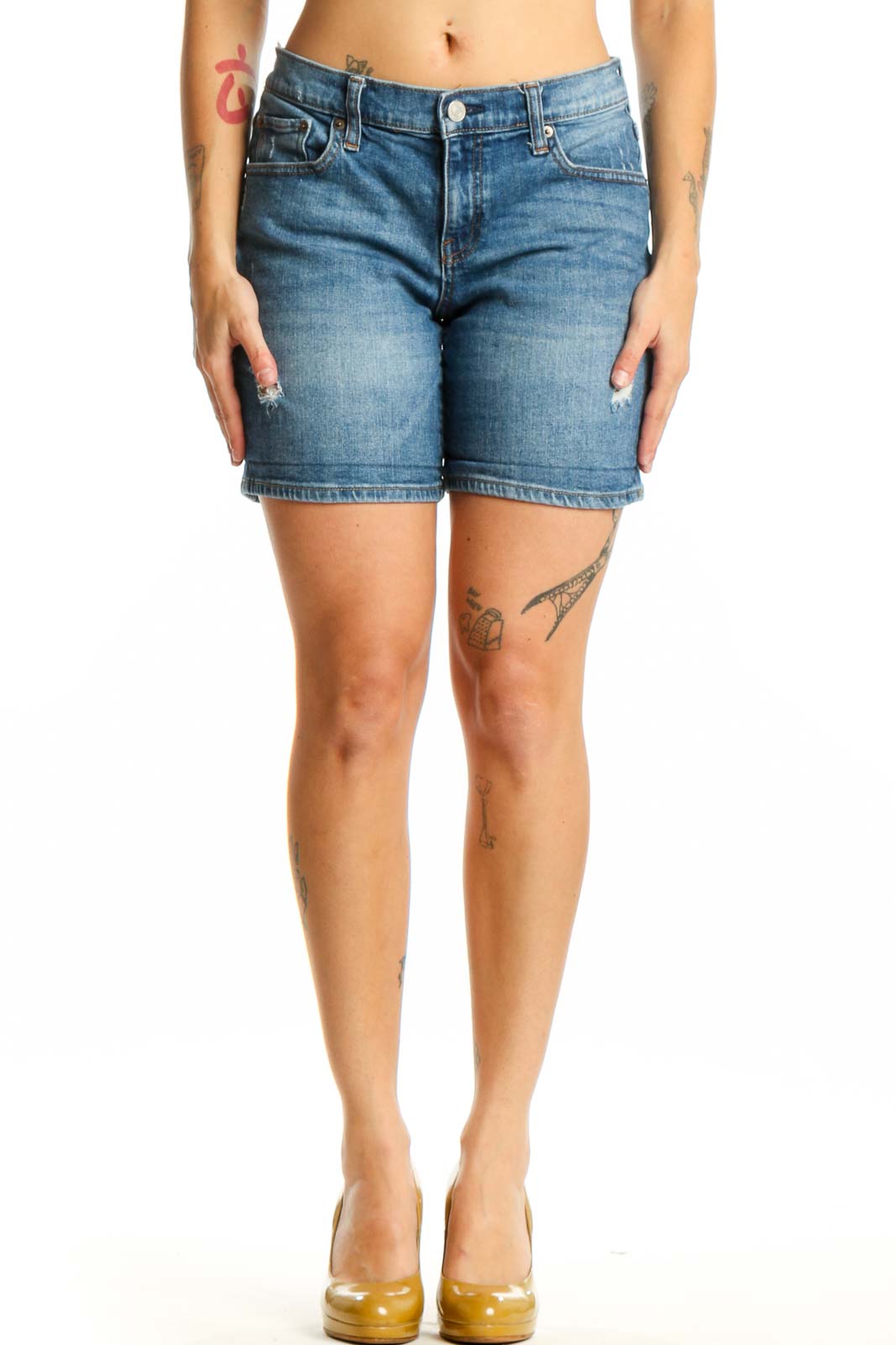 Blue denim shorts with distressed thigh details, classic five-pocket design, and mid-rise fit on model wearing size S
