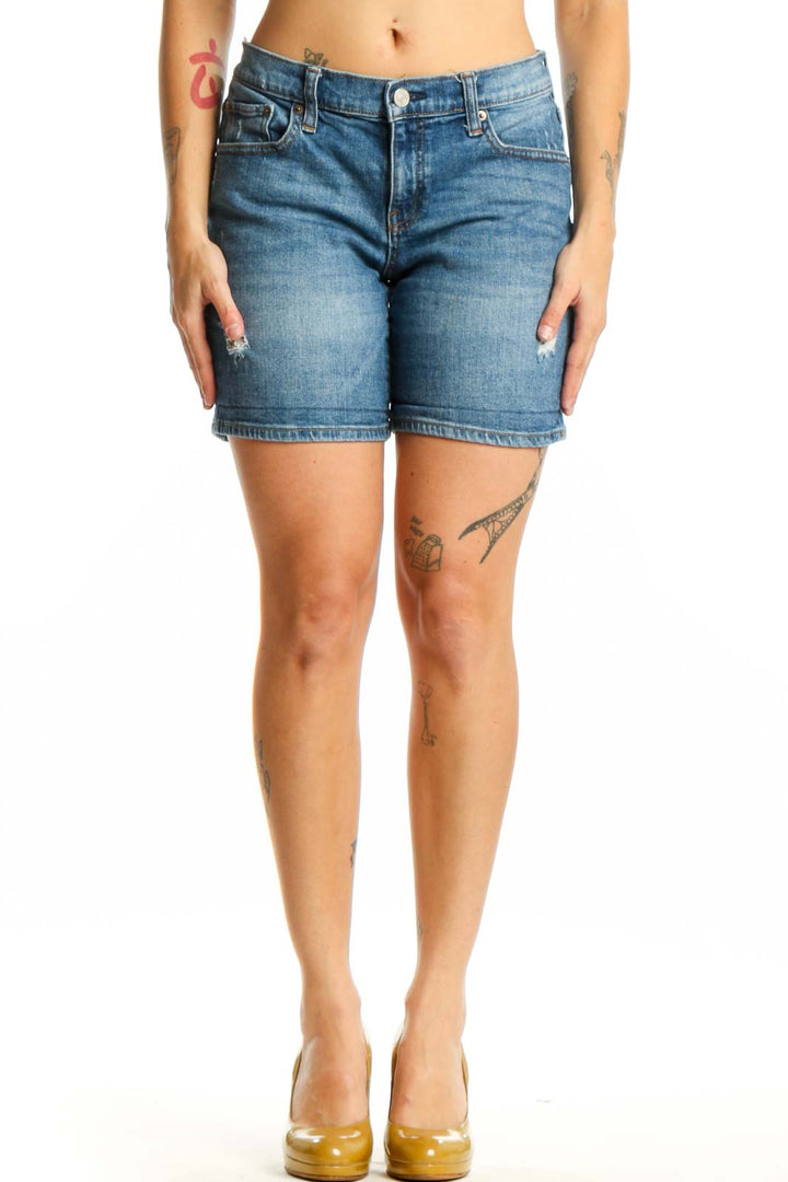Blue denim shorts with distressed thigh details, classic five-pocket design, and mid-rise fit on model wearing size S
