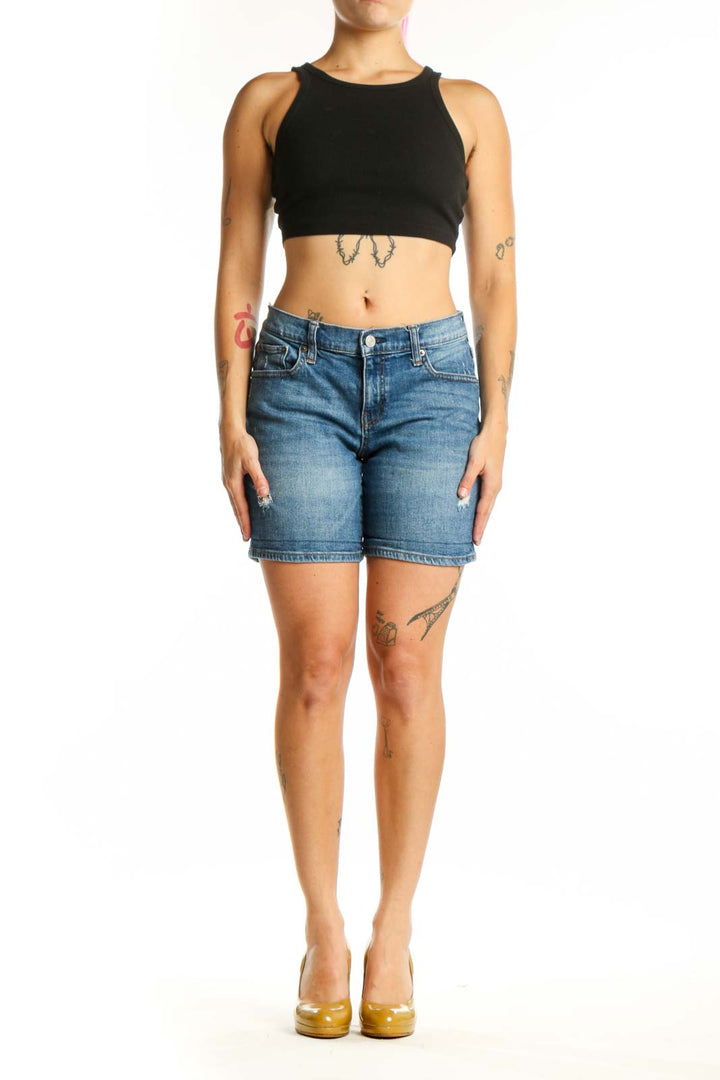 Blue denim shorts with distressed thigh details, classic five-pocket design, and mid-rise fit on model wearing size S