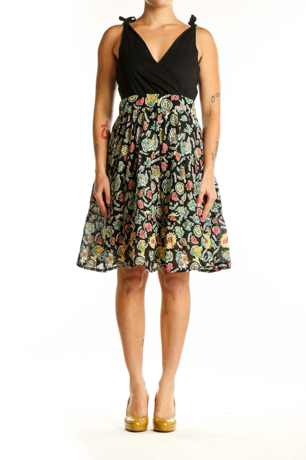 Black wrap midi dress with vibrant floral print skirt, tie-shoulder details, and V-neckline