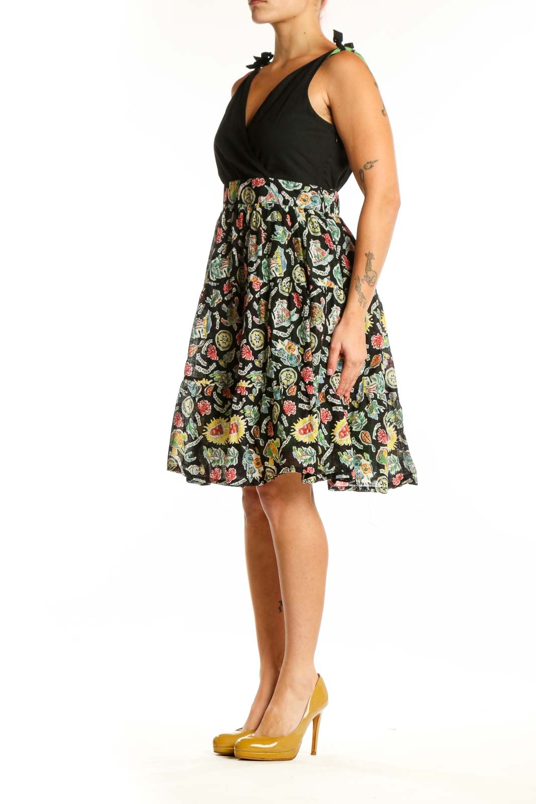 Black wrap midi dress with vibrant floral print skirt, tie-shoulder details, and V-neckline