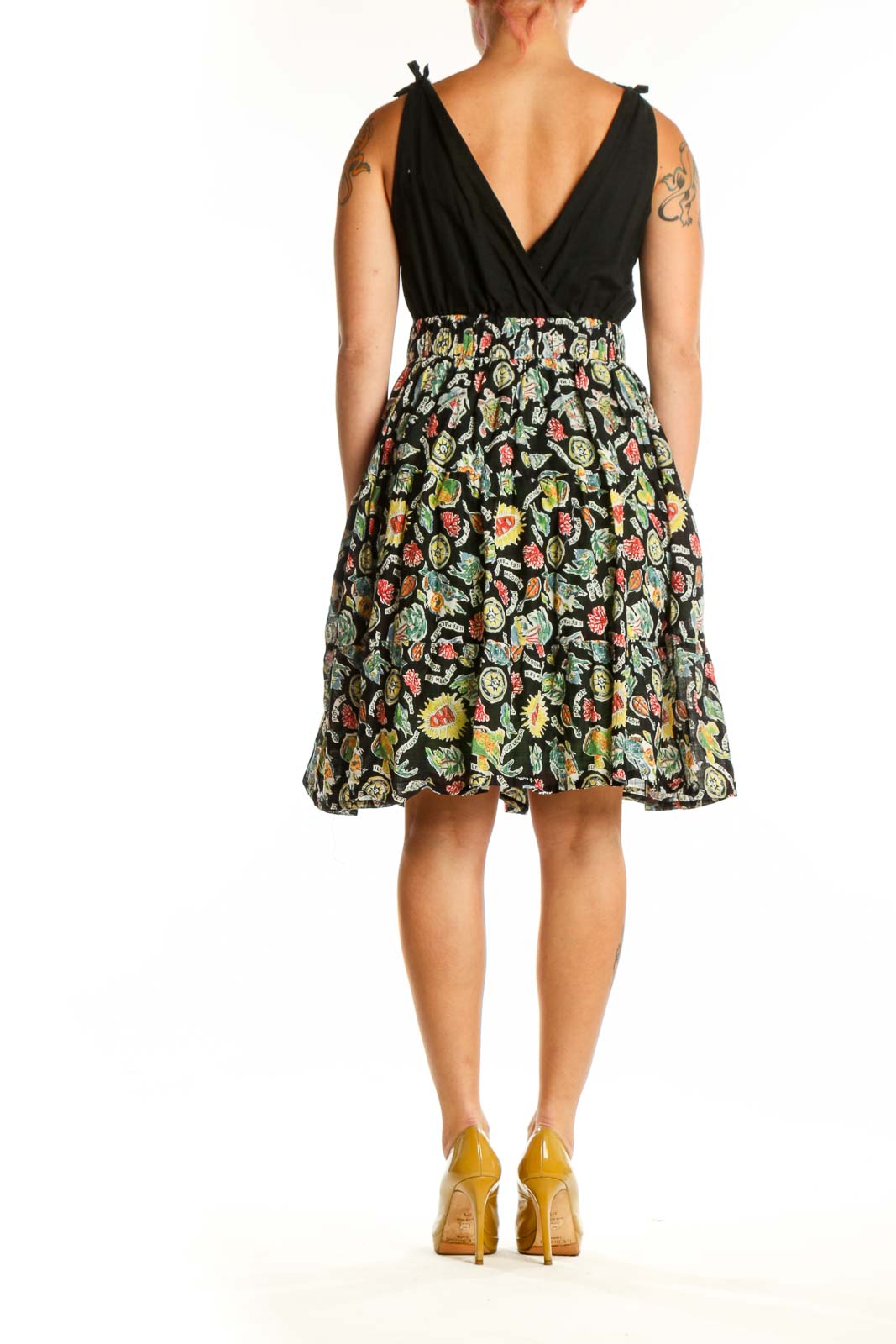 Back view of black floral wrap midi dress showing A-line silhouette and full skirt with botanical print
