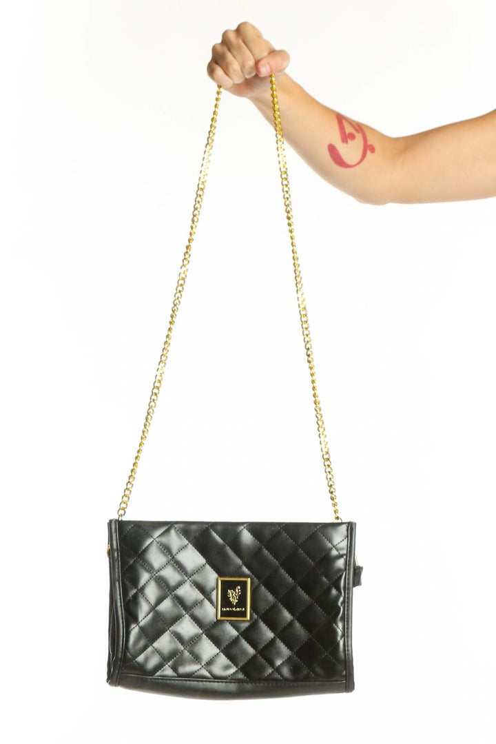 Black quilted PVC crossbody bag with gold chain strap and logo plaque, held in hand