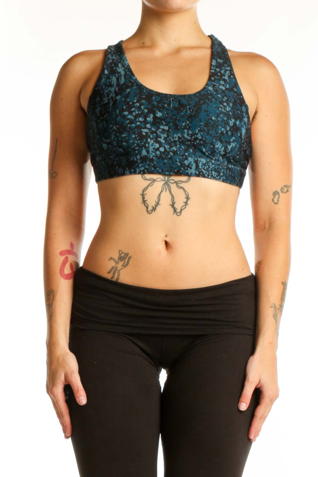 Teal velvet racerback sports bra with scoop neckline, front view on model wearing black leggings
