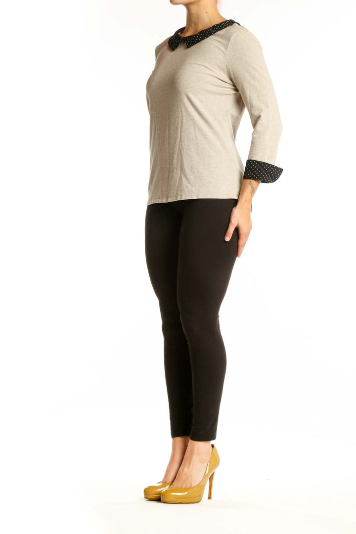 Cream long sleeve top with black polka dot Peter Pan collar and cuffs, front view