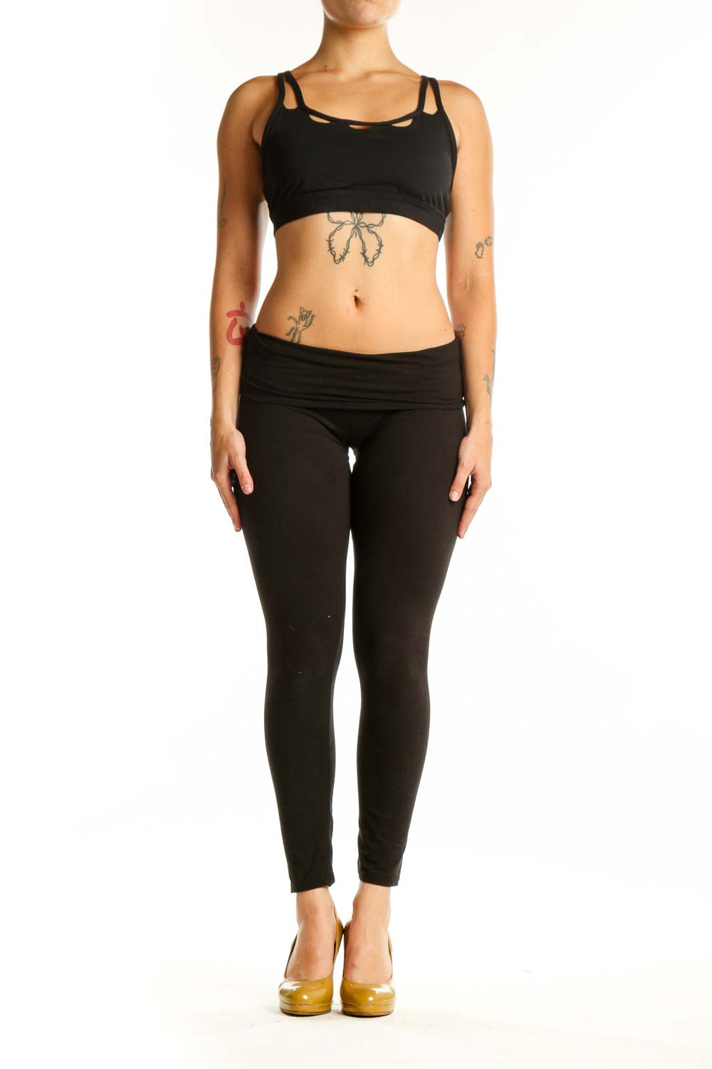 Black strappy sports bra with cutout details front view on model