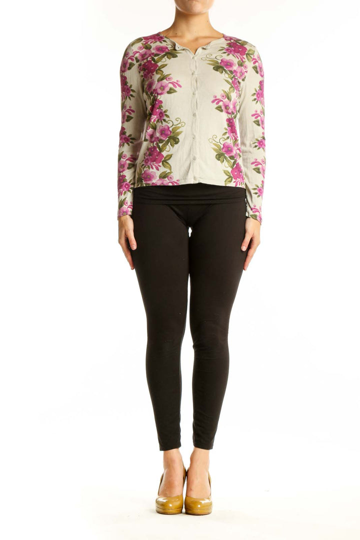 Cream cardigan with pink floral print, button-front closure, cropped silhouette, worn with black pants