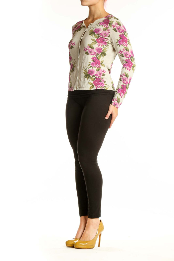 Cream cardigan with pink floral print, button-front closure, cropped silhouette, worn with black pants