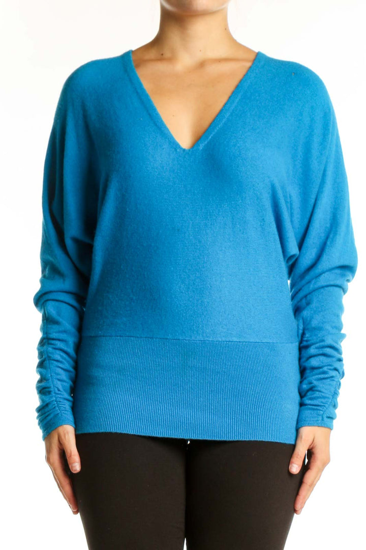 Blue V-neck cashmere blend knit sweater with ruched sleeves, front view on model