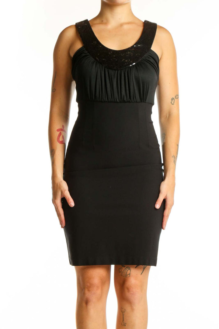 Black ruched cocktail dress with embellished neckline and empire waist by Maria Bianca Nero, front view
