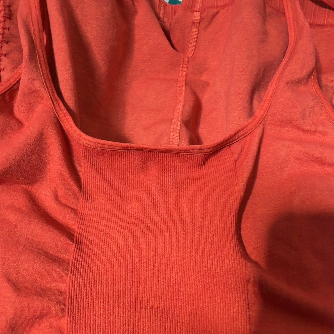 Red ribbed knit shorts romper with fitted back design and shorts length, back view