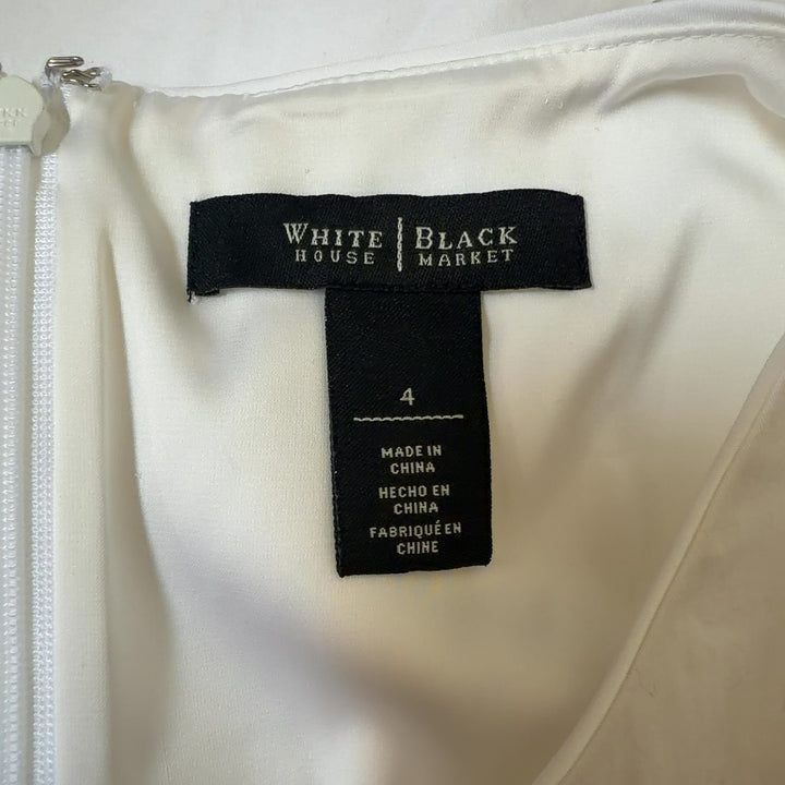 White House Black Market white sleeveless tie-front top back view showing tie detail and structured fit