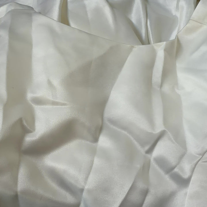 Tag view of cream sleeveless A-line midi dress showing elegant drape and silhouette