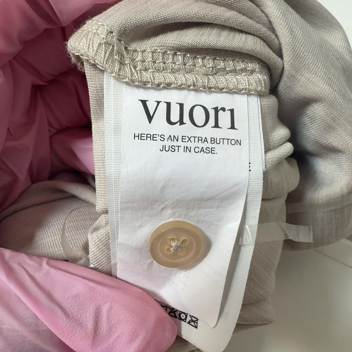 Tag view of cream sleeveless jumpsuit showing relaxed fit and side pockets