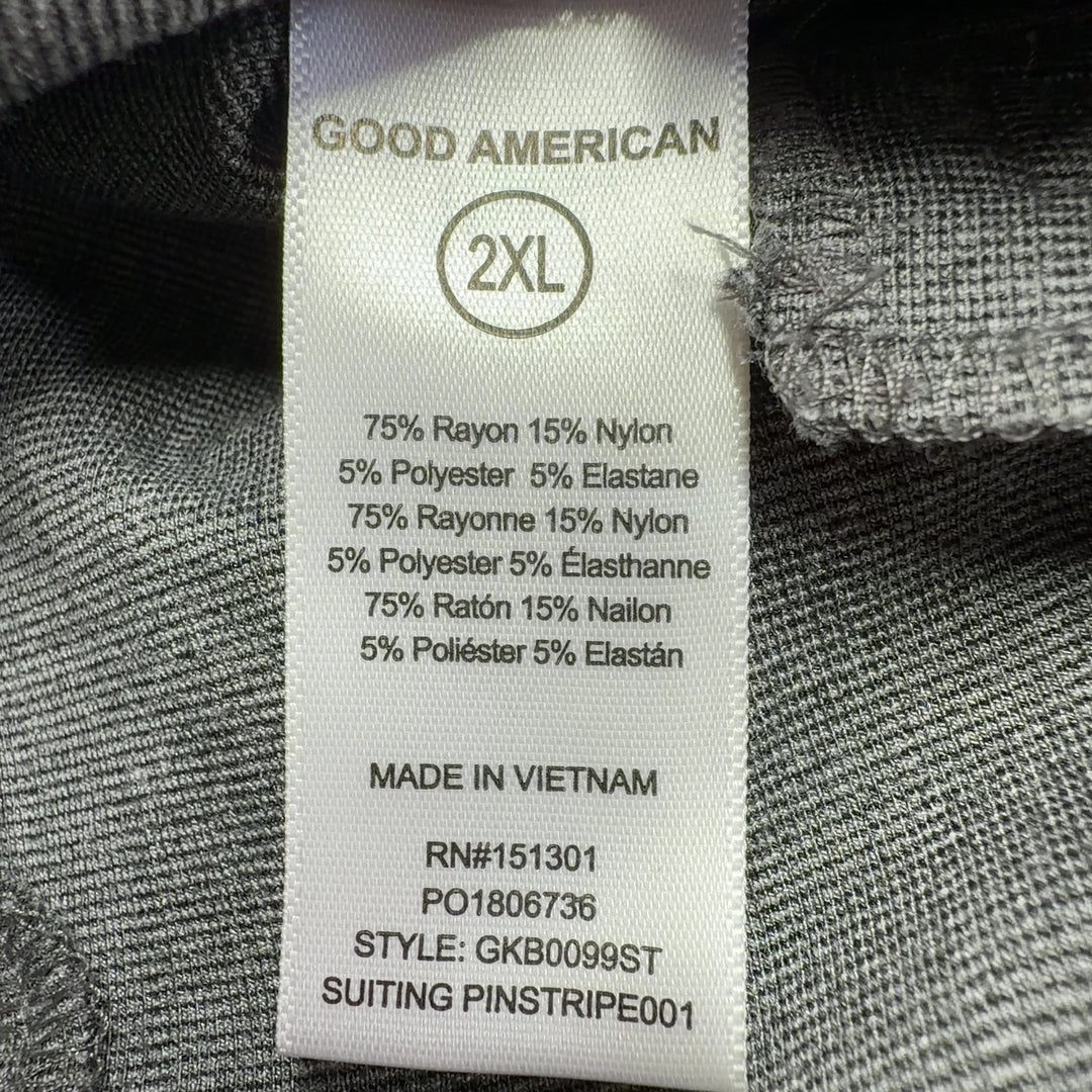 Tag view of gray pinstriped cropped flare pants showing flattering fit and cropped ankle length