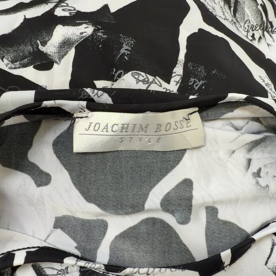 Black and white floral rose print top with three-quarter sleeves, back view on model