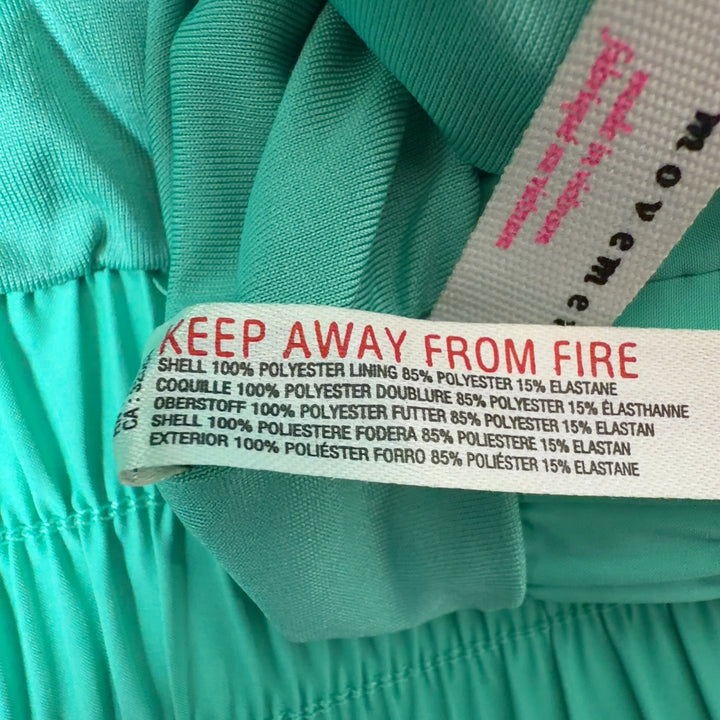 Mint green ruched athletic shorts with high waistband and flared hem, back view