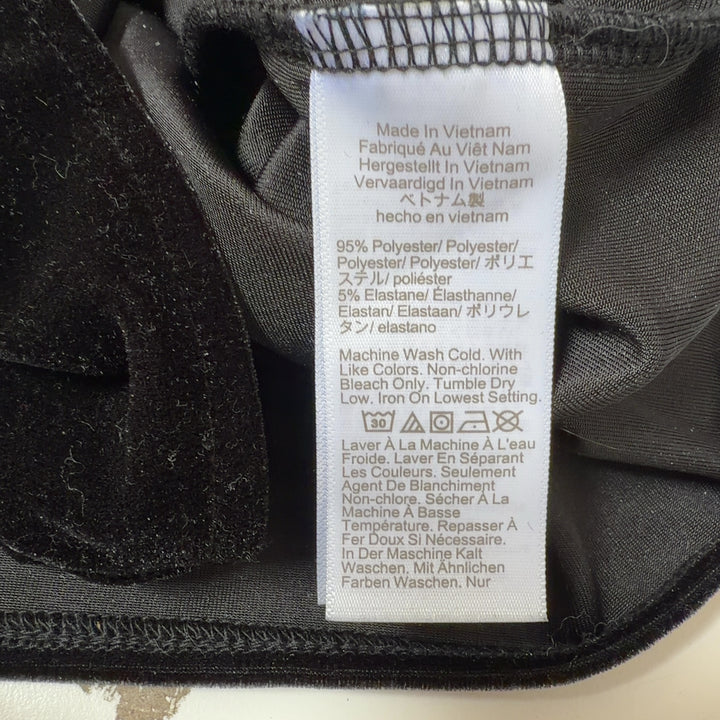 Black velvet sleeveless V-neck top by J.Crew, back view on model
