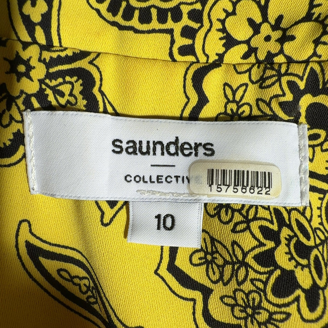Yellow floral button-up blouse with botanical print, back view showing relaxed fit