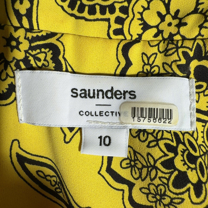 Yellow floral button-up blouse with botanical print, back view showing relaxed fit