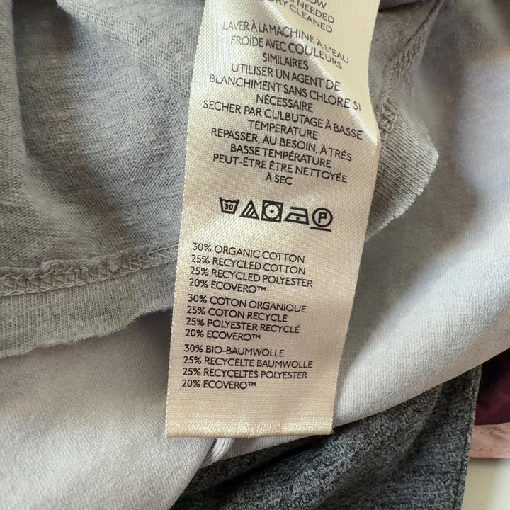 Gray organic cotton short sleeve tee by WE THE FREE, back view on model wearing black leggings