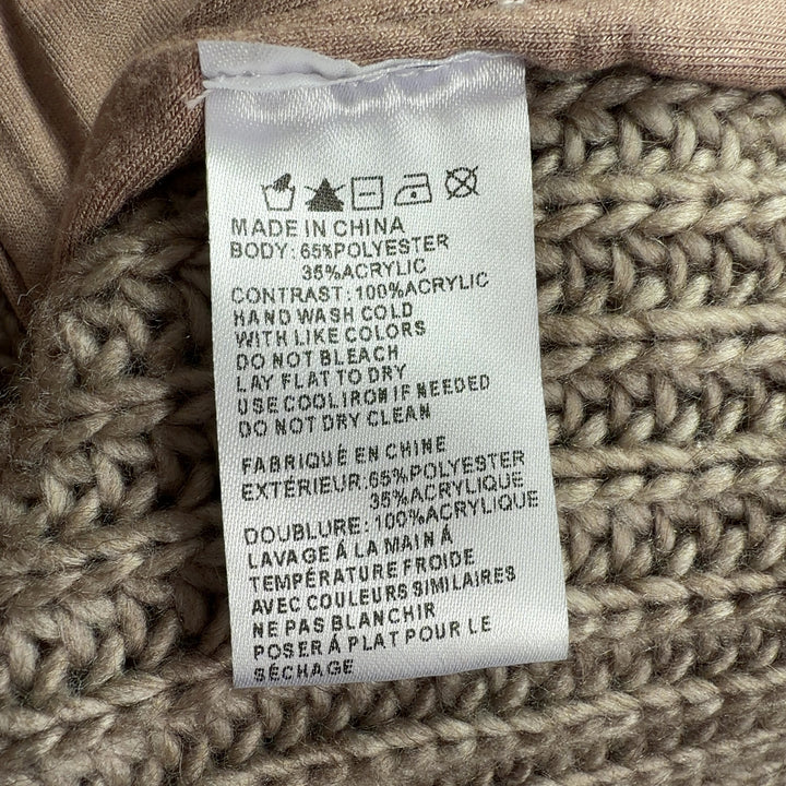 Tag view of beige textured knit vest showing full-length zipper and sleeveless design