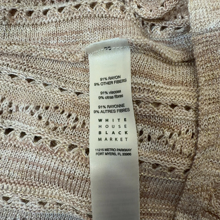 Cream ruffled v-neck knit top with eyelet detailing and flutter sleeves, back view