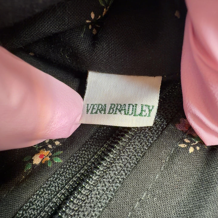 Tag view of brown quilted Vera Bradley satchel displaying floral pattern and embroidered details