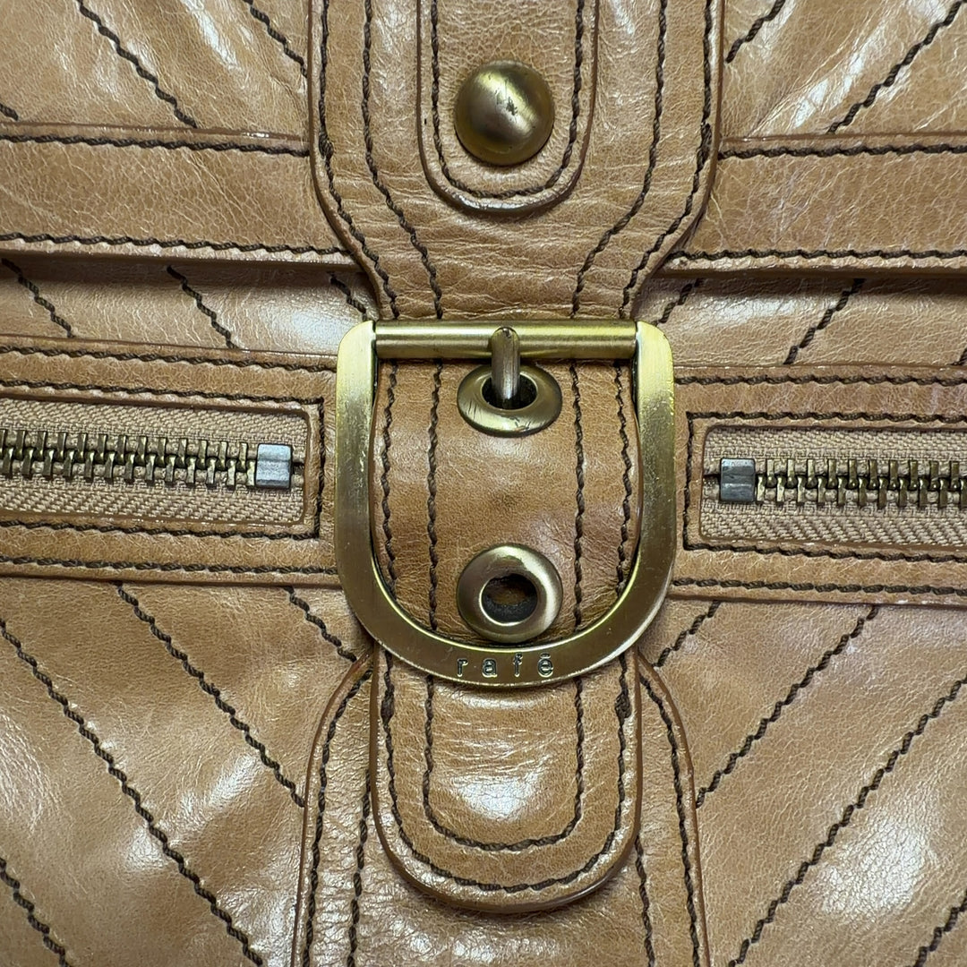 Tag view of tan quilted leather shoulder bag worn as crossbody style with chain strap