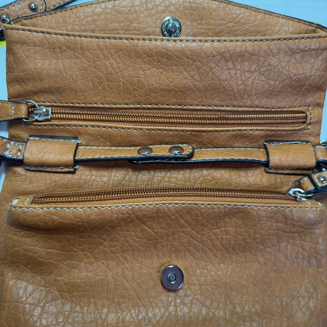 Orange leather crossbody bag worn as crossbody style, back view on model
