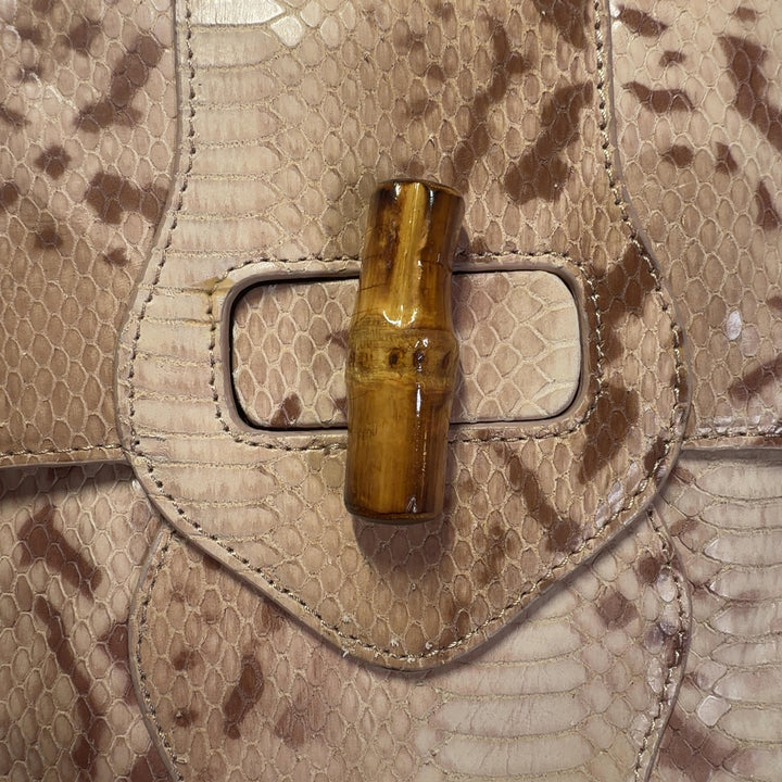 Tag view of cream velvet Elaine Turner shoulder bag worn as shoulder bag, showing structured silhouette and chain strap detail